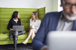 © Cavan Images - Happy businesswomen talking while working in office with male colleague in foreground
