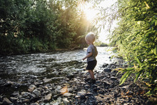 Side View Of Boy Standing Near River