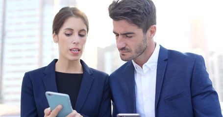 Wall Mural - Business people using cellphone together