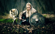 Viking woman warrior in traditional armour close to a wild wolf in forest - Cinematic look