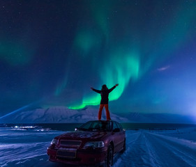 Wall Mural - the polar arctic northern lights aurora borealis sky star in norway svalbard man in longyearbyen cit