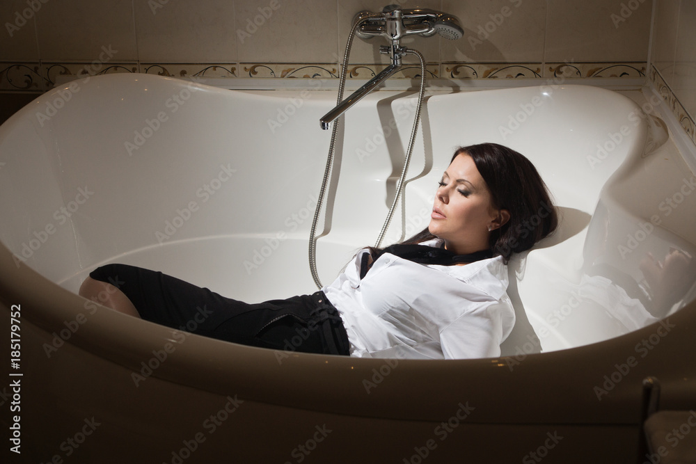 Strangled beautiful business woman in a bedroom. Stock Photo | Adobe Stock