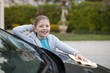 © WavebreakMediaMicro - Teenage girl washing a car on a sunny day