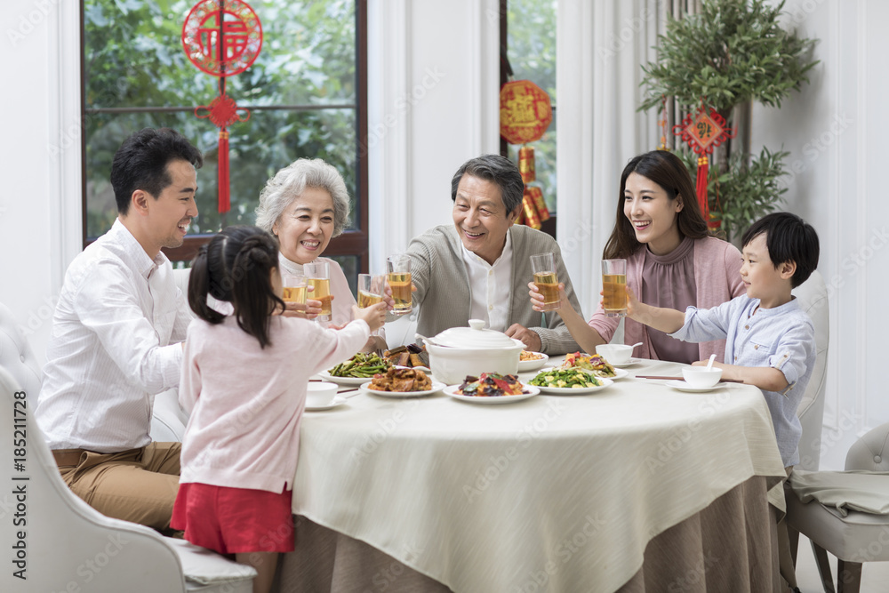 Happy family having dinner and celebrating Chinese New Year Stock Photo ...