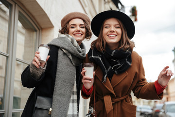 Poster - Portrait of two happy girls dressed in autumn clothes