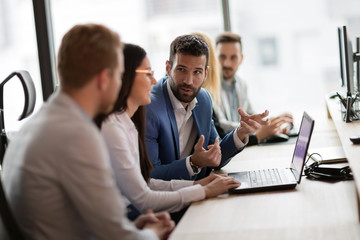 Young businesspeople working on computer in office