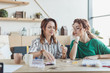 © LIGHTFIELD STUDIOS - young concentrated women making accessories in handmade workshop