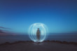 © Gonzales Photo - Person creating light ball at seashore at night