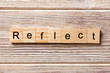 canvas print picture - Reflect word written on wood block. Reflect text on table, concept