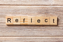 Reflect Word Written On Wood Block. Reflect Text On Table, Concept