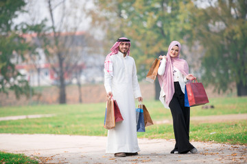 Wall Mural - Lovely uslim couple taking a walk after shopping