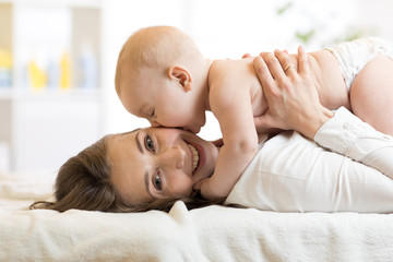 Adorable baby kissing his mother