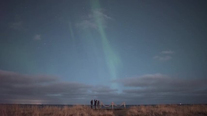 Wall Mural - three women veiwing twilight aurora borealis by ocean, realtime, iceland.mov
