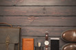 Top view, men's fashion personal belongings and accessories with space on a dark wooden background. Leather bag, shoes, watch.