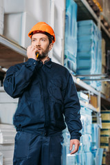 Wall Mural - male worker in helmet with walkie talkie in shipping stock