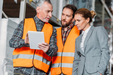 Wall Mural - workers and inspector using digital tablet in storehouse