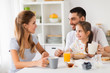© Syda Productions - happy family having breakfast at home