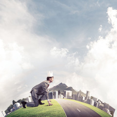 King businessman in elegant suit running on green globe with mod