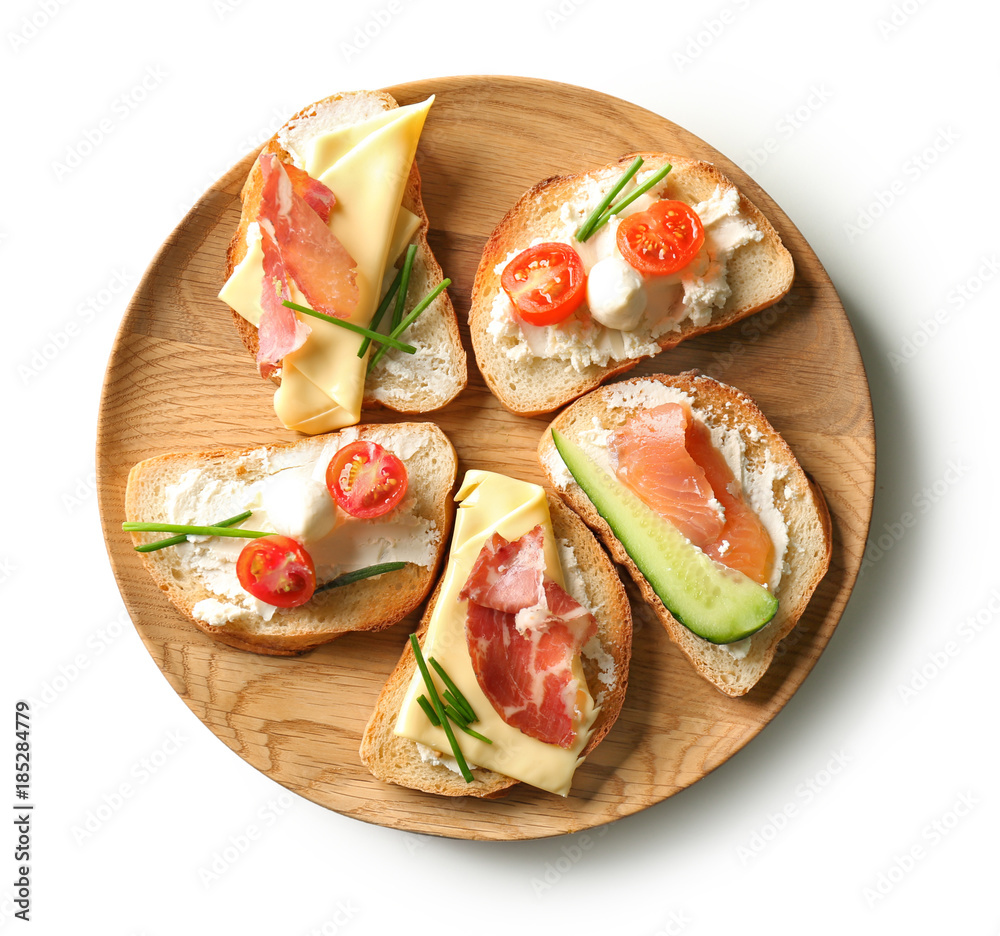 Plate with delicious sandwiches on white background, top view