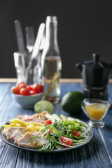 Plate with meat and delicious fresh salad on table