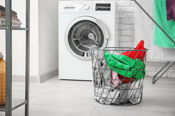 Wall Mural - Basket with laundry and washing machine in bathroom