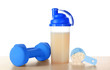 Protein shake in bottle, scoop with powder and dumbbells on table against white background
