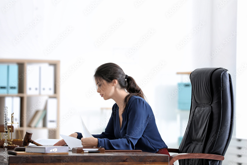 Young female notary working in office