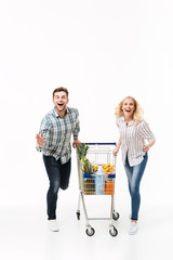 Sticker - Full length portrait of a cheerful couple running