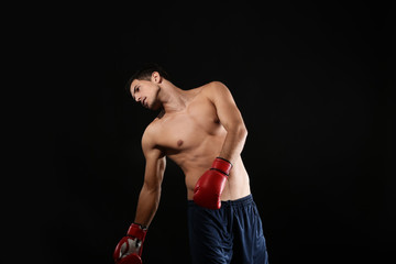 Sticker - Attractive young boxer on black background