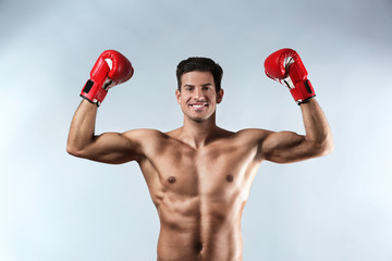 Poster - Attractive young boxer on light background