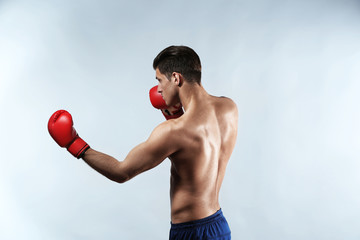 Poster - Attractive young boxer on light background