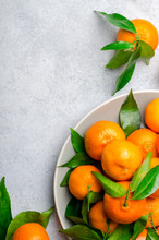 Fresh Clementines On A Gray Plate On A Light Stone Background. T