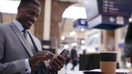 Business man using his phone one morning in a public space