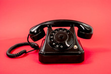 Retro Black Phone Isolated On A Red Background