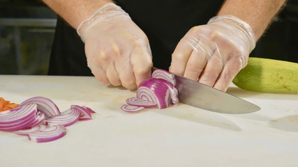 Professional chef chopping vegetables, close-up