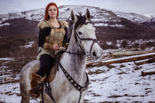 Fotografie, Obraz Viking woman with hammer in a traditional warrior clothes.