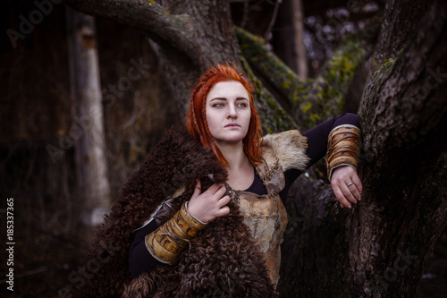 Fotografie, Obraz Viking woman with hammer in a traditional warrior clothes.