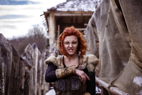 Fotografie, Obraz Viking woman with hammer in a traditional warrior clothes.