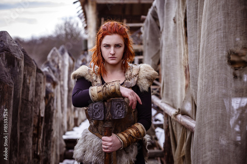 Fotografie, Obraz Viking woman with hammer in a traditional warrior clothes.