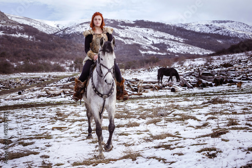 Fotografie, Obraz Viking woman with hammer in a traditional warrior clothes.