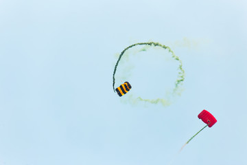 Two Parachutists fly to the blue sky