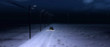 Four-wheel drive vehicle on rural road covered in snow at night.