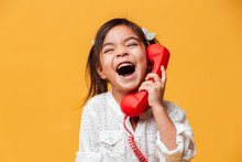 Screaming Excited Little Girl Child Talking By Red Retro Telephone.