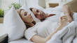 © silverkblack - Closeup of couple with relationship problems having emotional conversation while lying in bed at home