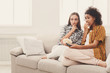 © Prostock-studio - Frightened young women watching TV at home