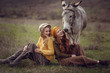 © Olena_Molchanova - Two charming young women rest on nature together with a cute donkey.
