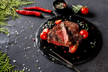 Wall Mural - Rare rib eye steak on dark plate