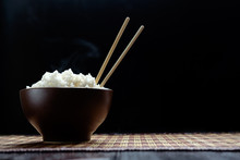 Hot Rice In Brown Bowl With Chopsticks In Japanese Style