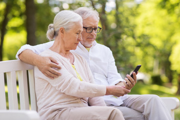 Sticker - happy senior couple with smartphone at park