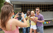 © Syda Productions - woman photographing friends eating at food truck